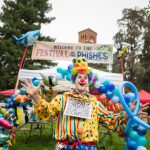 A clown creates fish balloons at the cybersecurity-themed carnival Festival of the Phishes on campus at Chico State.