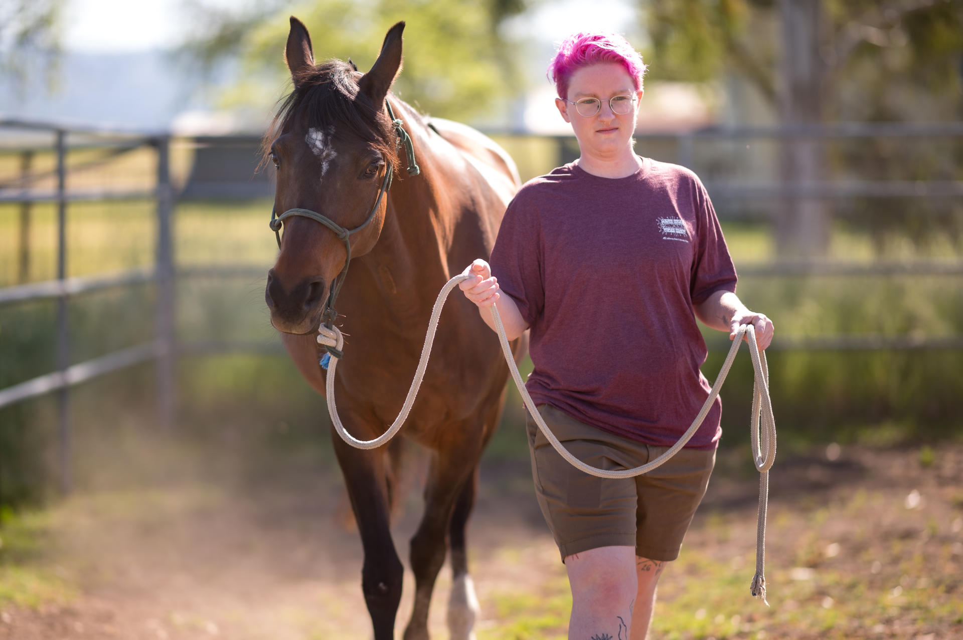 Megan Knaus holds the reins as she leads a horse.