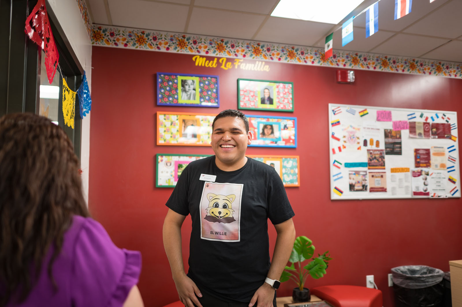 Ermelindo Salgado Hernandez stands near the door to El Centro as he greets a visitor during the grand opening celebration. 